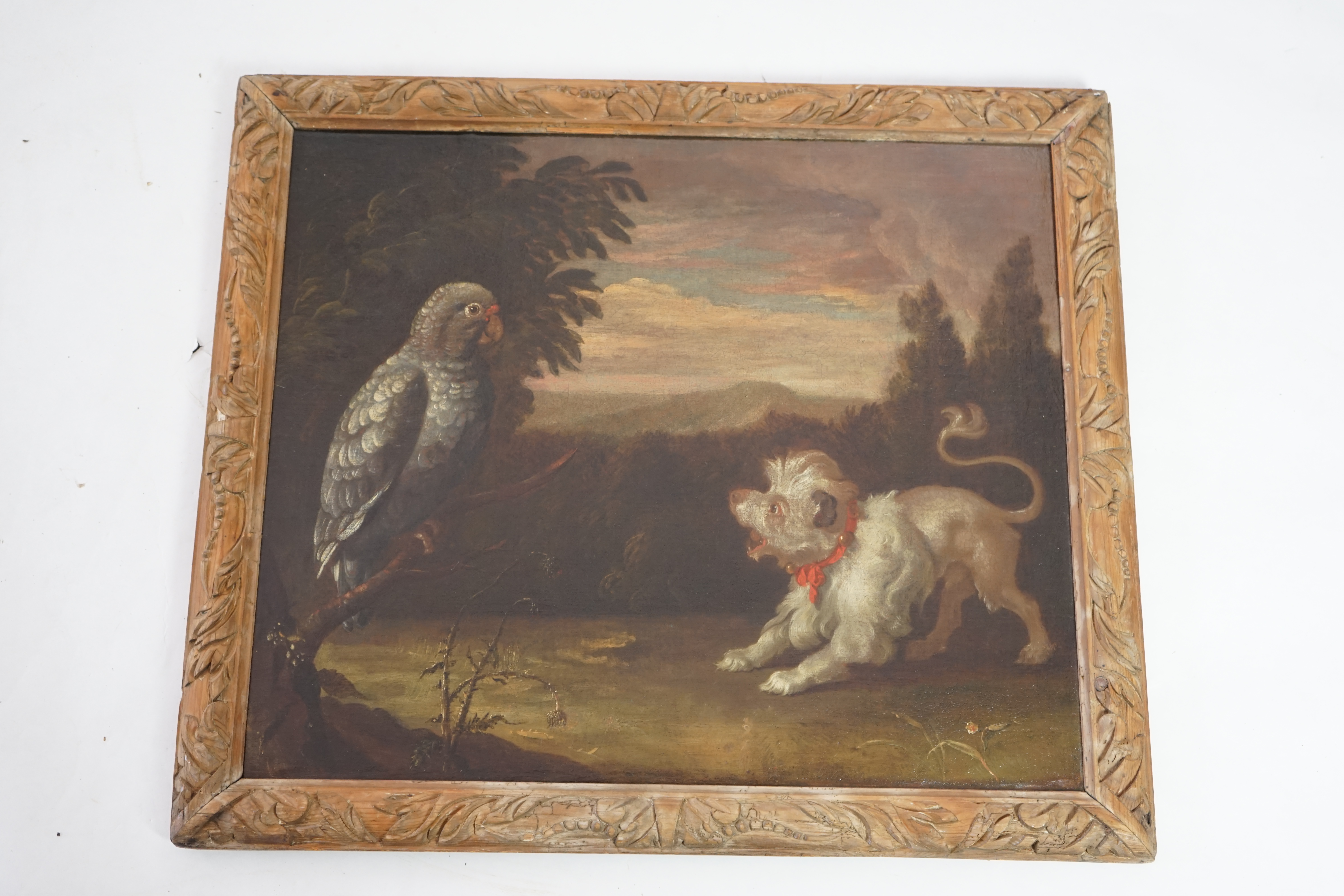 Circle of Francis Barlow (British, 1624-1724), Lion-dog and a grey parrot in landscape, oil on canvas, 62 x 74cm